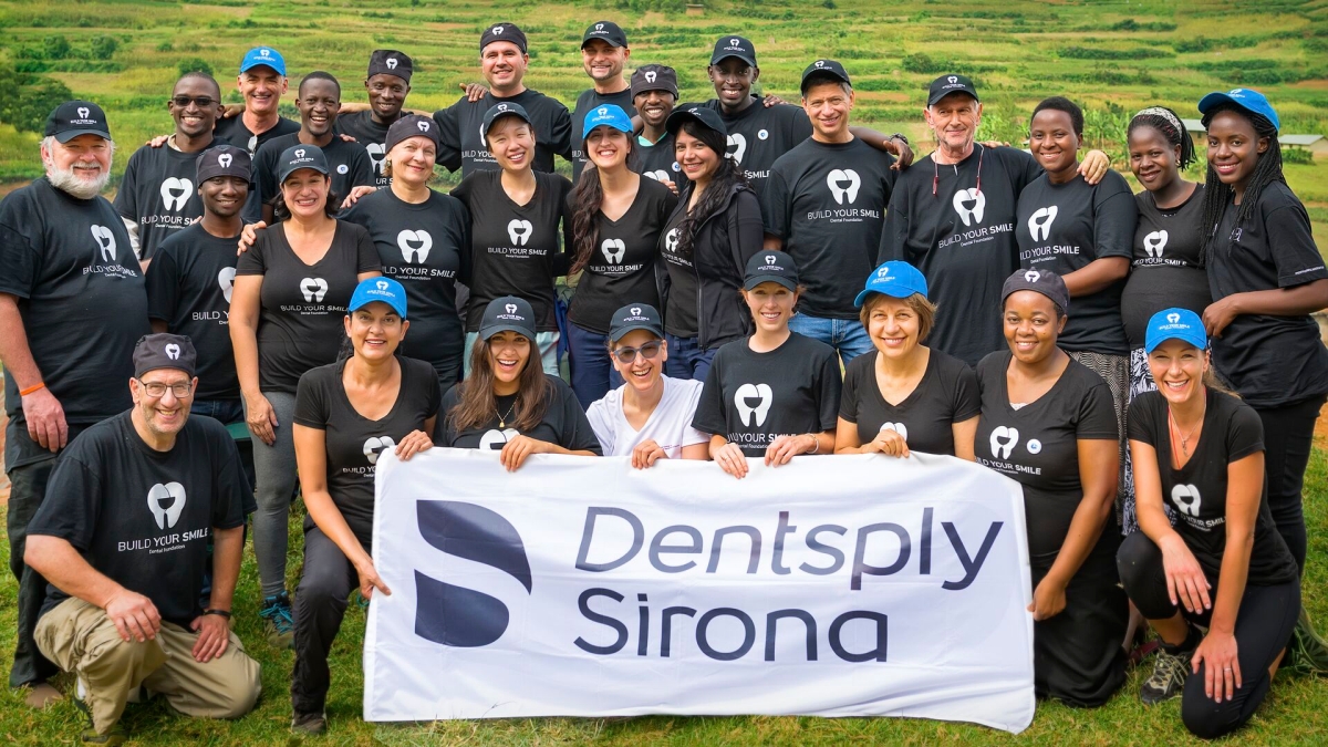 A group of Dentsply Sirona employees holding a banner for the Build Your Smile Foundation